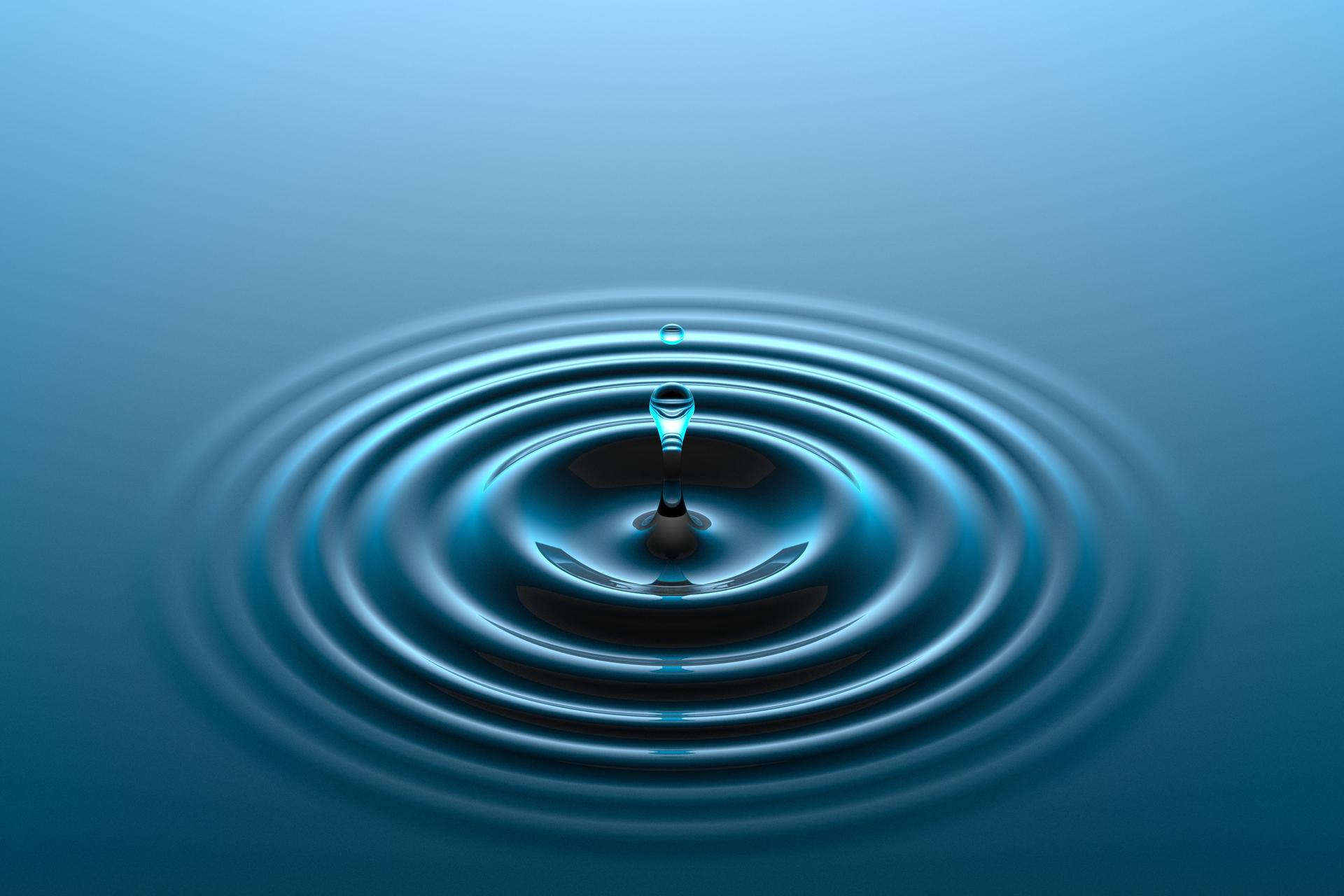 Water drop falling into water surface